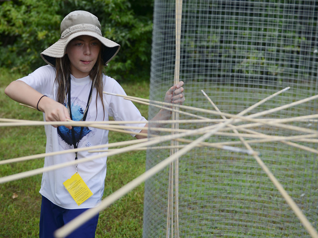 Boone Dawdle volunteer Phoenix Ribiat, 12, resets the Giant Kerplunk game